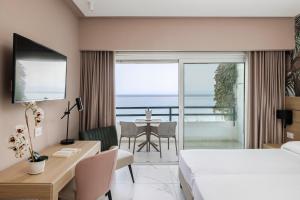a hotel room with a bed and a desk and a table at Aldiana Club Rocca Nettuno Calabria in Tropea