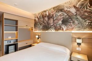 a bedroom with a bed and a fireplace at Aldiana Club Rocca Nettuno Calabria in Tropea