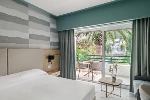 a hotel room with a bed and a balcony at Aldiana Club Rocca Nettuno Calabria in Tropea