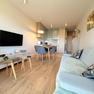 a living room with a blue couch and a table at Apartament GJ PLAZA in Kielce