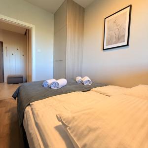 a bedroom with a bed with three pillows on it at Apartament GJ PLAZA in Kielce +10 photos
