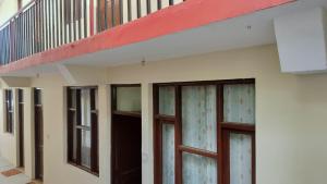 a row of doors and windows on a building at Bhagsunag Nizu Palace in McLeod Ganj