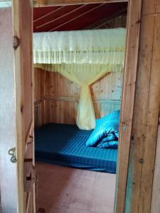 a bunk bed in a room with a blue bed at Nhà Gỗ Cổ homestay Lao xa in Dồng Văn