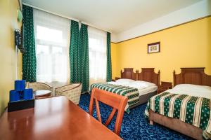 Postel nebo postele na pokoji v ubytování Hotel Otakar