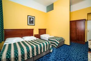 Postel nebo postele na pokoji v ubytování Hotel Otakar