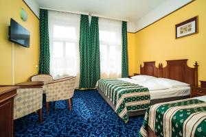Postel nebo postele na pokoji v ubytování Hotel Otakar