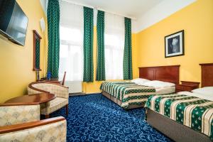 Postel nebo postele na pokoji v ubytování Hotel Otakar