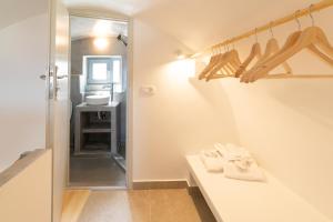 a bathroom with a white counter and a sink at Dauti Gold Suites in Vóthon +45 photos