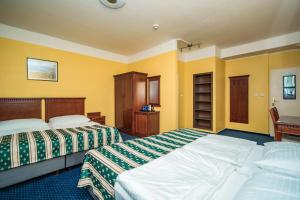 Postel nebo postele na pokoji v ubytování Hotel Otakar