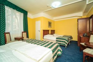 Postel nebo postele na pokoji v ubytování Hotel Otakar
