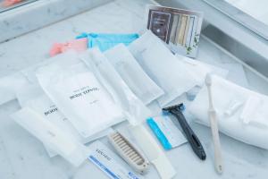 a pile of white towels and toothbrushes on a counter at Hotel Marital Sousei Kurume in Kurume