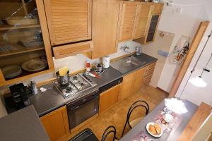 a small kitchen with a stove and a sink at La Casetta Vicino al Mare in San Vincenzo