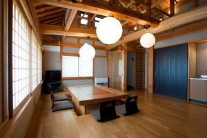 a large room with a wooden table and some lights at Izumigo Takayama Dog Paradise Hotel in Takayama
