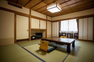 a living room with a wooden table and chairs at Izumigo Takayama Dog Paradise Hotel in Takayama