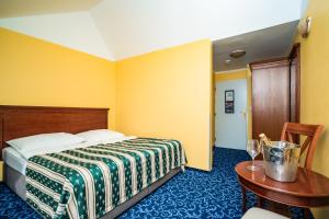 Postel nebo postele na pokoji v ubytování Hotel Otakar