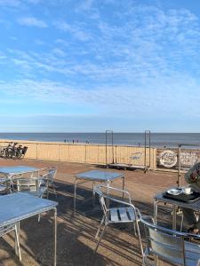 a group of tables and chairs next to the beach at Lovely Serenity 1 and 2 caravans are situated on the Norfolk Broads in Lowestoft +29 photos