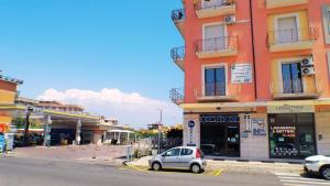 a small car parked in front of a building at Soverato Sweet Home 13 in Soverato Marina