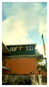 a building with a flag on top of it at Hotal North 4 Star darjeeling in Darjeeling