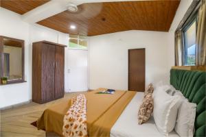 a bedroom with a bed and a wooden ceiling at Newly Renovated-Farm Villa -6BHK with Pool & Turf in Lonavala +31 photos
