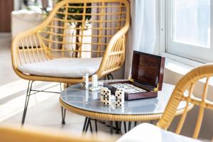 a laptop sitting on a table with dominoes at 800 Mountain Resort Vacation House in Fujairah