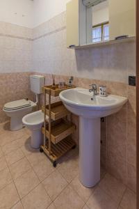 a bathroom with a sink and a toilet at vacation home Nonno Costa in Fara Novarese +4 photos