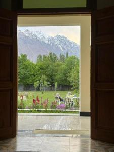 a view of a garden through a doorway at Cherry Orchard Inn in Mastūj