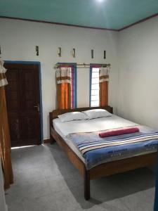 Postel nebo postele na pokoji v ubytování bulan homestay
