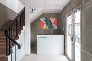 a hallway with a staircase with a sign on the wall at Mono Coliving Brotojoyo, Semarang in Stasiun Tawang