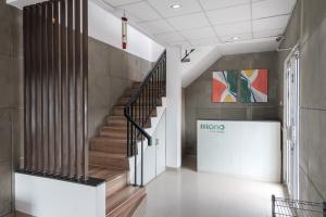 a hallway with a staircase in a building at Mono Coliving Brotojoyo, Semarang in Stasiun Tawang