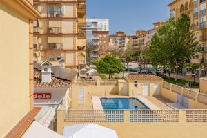 a view from the balcony of a building with a swimming pool at Piso Vacaciones En Fuengirola in Fuengirola