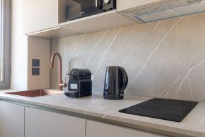 a kitchen with a coffee maker on a counter at Havre de paix à proximité de Lyon in Écully