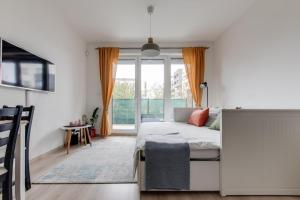 a bedroom with a bed and a large window at Brand-new, equipped studio near the metro in Prague +34 photos
