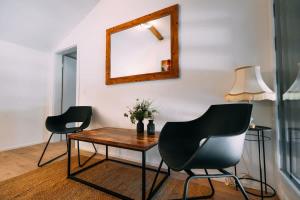 a room with two chairs and a table and a mirror at Lakeside Barn Apartment near Interlaken in Bönigen +18 photos