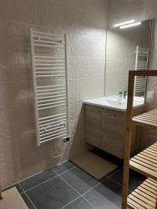 a bathroom with a sink and a mirror at Midori T3 77 m2 in Vars