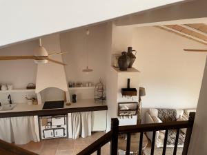 a living room with a kitchen and a staircase at Alodia in Alquézar