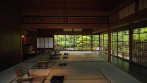 a large room with chairs and tables and windows at KAWAZU Gastronomy & Traditional Inn in Mashizume