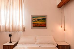 a bedroom with a bed and a painting on the wall at Cantina Rustica in Montallegro