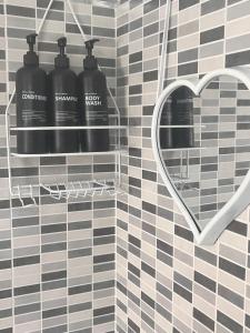 a bathroom with a heart shaped mirror and two black buffers at Marilyn House in Ladispoli +9 photos