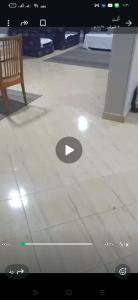 a picture of a room with a chair on a tiled floor at شقة مفروشة فري in Cairo