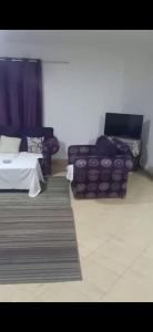 a living room with a bed and a couch at شقة مفروشة فري in Cairo