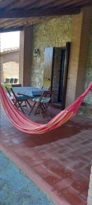 a hammock on the patio of a house at 2girasoli piano terra in Pucciarelli