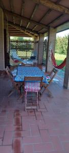 a patio with a table and chairs on a patio at 2girasoli piano terra in Pucciarelli +27 photos
