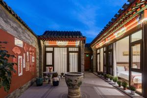 a courtyard of a building with a vase at Liuli Tile Courtyard Hotel Tian Anmen Wangfujing Houhai in Beijing