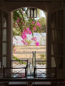 a table with two vases on top of a window at Dar 'Villa Blanche' in Djerba