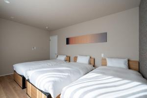 En eller flere senge i et værelse på RERESO Motohakone