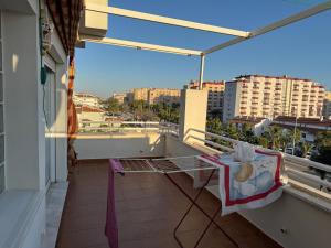 a bed on a balcony with a view of a city at Apartamento Torrox5 in Torrox Costa