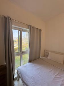 a bedroom with a bed and a large window at منتجع جبل السيفه in Muscat +33 photos