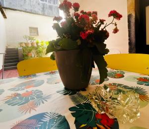 a vase filled with flowers sitting on a table at Casa in centro a Giarre in Giarre