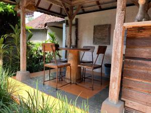 a table and chairs sitting on a patio at Tuwi Villa Ubud in Ubud