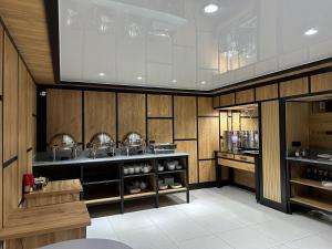 a kitchen with wooden walls and a counter with dishes at Safia Guest House in Andijan